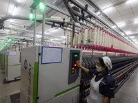 A worker is operating an intelligent production line at a textile company in Taizhou, Jiangsu Province, China, on March 26, 2024. (