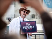 A doctor participates in an anti-abortion demonstration at the Supreme Court as it hears oral arguments in a case that could end access to m...