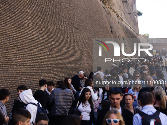 People stand in a line to the Vatican Museum in Rome, Italy on March 25, 2024. (
