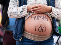 A pregnant anti-abortion activist partcipates in a demonstration at the Supreme Court as it hears oral arguments in a case that could end ac...