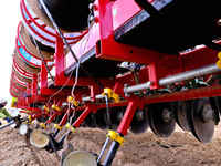 Farmers are installing drip irrigation belts for an integrated seeding machine pulled by a Beidou Navigation automatic driving tractor at th...