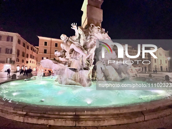 The fountain in Piazza Navona is illuminated at night in Rome, Italy, on March 24, 2024. (