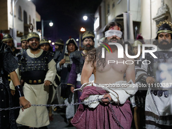 A person representing Jesus Christ is being escorted by Roman soldiers during the 58th reenactment of the apprehension of Christ on Holy Thu...
