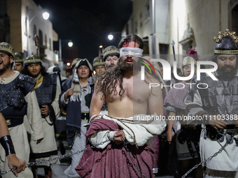 A person representing Jesus Christ is being escorted by Roman soldiers during the 58th reenactment of the apprehension of Christ on Holy Thu...