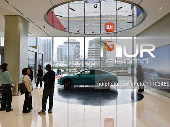 Customers are viewing the XIAOMI SU7, Xiaomi's first electric supercar, at the company's East China headquarters in Nanjing, Jiangsu Provinc...
