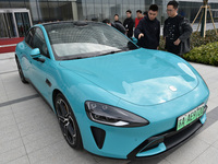 Customers are viewing the XIAOMI SU7, Xiaomi's first electric supercar, at the company's East China headquarters in Nanjing, Jiangsu Provinc...