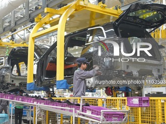 A worker is assembling auto parts on a production line at the Li Auto Manufacturing base in Changzhou, Jiangsu Province, China, on March 27,...