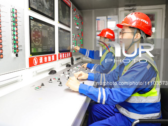 A worker is controlling the ''Haitian'' shield machine at the construction site of the Second Undersea Tunnel project at Qingdao Jiaozhou Ba...
