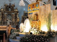 Altar servers and a parish volunteer are preparing the Altar of Repose at the Franciscan-run Basilica Minore de San Pedro Bautista in Quezon...