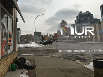 EDMONTON, CANADA - MARCH 28:
A homeless person sleeps on the pavement in downtown Edmonton area, on March 28, 2024, in Edmonton, Alberta, Ca...