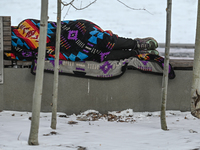 EDMONTON, CANADA - MARCH 28:
A homeless person sleeps on the public bench in downtown Edmonton area, on March 28, 2024, in Edmonton, Alberta...