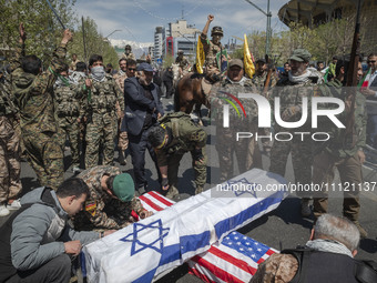 Members of the Islamic Revolutionary Guard Corps (IRGC) are preparing coffins that symbolize the death of Israel and the U.S. to be set on f...