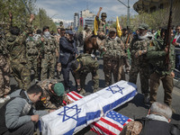 Members of the Islamic Revolutionary Guard Corps (IRGC) are preparing coffins that symbolize the death of Israel and the U.S. to be set on f...