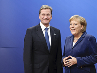 Germany's Federal Chancellor Angela Merkel  and German Foreign Minister Guido Westerwelle (L) during arrivals for an EU summit in  Brussels...