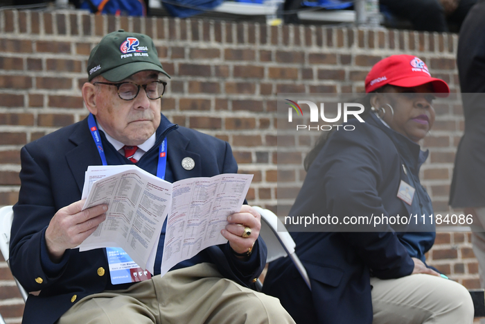 Officials are standing on the sidelines while athletes are competing on day 3 of the 128th Penn Relays Carnival, the largest track and field...