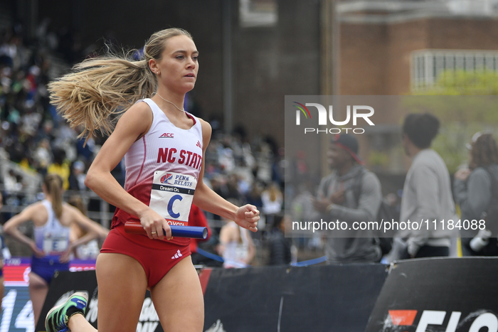 NC State runners Grace Hartman, Amaris Tyynismaa, Hannah Gapes, and Samantha Bush are leading in the College Women's 4x1500 Championship of...