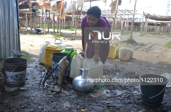An Indian woman collect drinking water from a supply line on the World Water Day in Dimapur, India north eastern state of Nagaland on Tuesda...