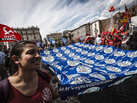 Rome, Italy – May 17, 2014: Protesters wave a flag as they demonstrate during a nationwide demonstration against the privatization of the co...