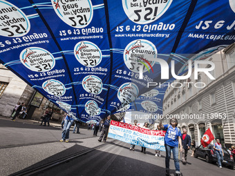 Rome, Italy – May 17, 2014: Protesters wave a flag as they demonstrate during a nationwide demonstration against the privatization of the co...