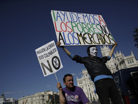Protestors display banners during a protest against austerity, banners say 