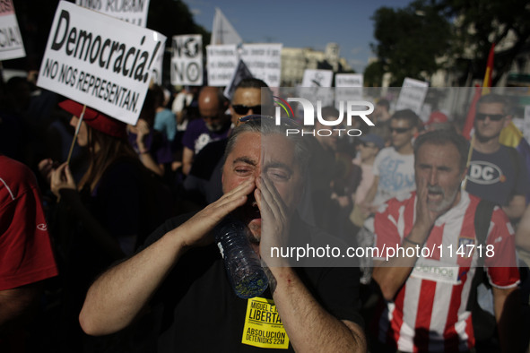 Protestors shout slogans during a protest against austerity in Madrid, Spain , May 17th 2014. Protestors from different collectives have mar...