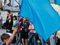 A boy holds the Crimean Tatars blue flag during the action in Kiev to commemorate the 70-th anniversary of Stalin's deportation of the Crime...