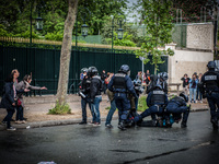 A protester has stopped with force by police booed bystanders during a protest after the French government made use of the constitution's Ar...
