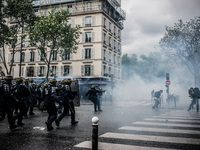 French Riot Police charge during a protest after the French government made use of the constitution's Article 49-3 allowing them to bypass p...