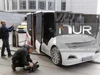 People look at the prototype of a new Ukrainian electric car 