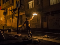 A protester with molotov cocktail during clashes with police in the Alevi enclave of Okmeydani on Istanbul on May 26, 2014. (