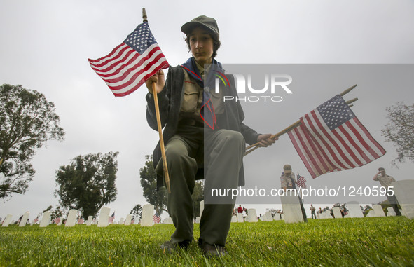 Boy scouts carry U.S. flags to plant at each grave at the Los Angeles National Cemetery, for the Memorial Day in Los Angeles, California, th...