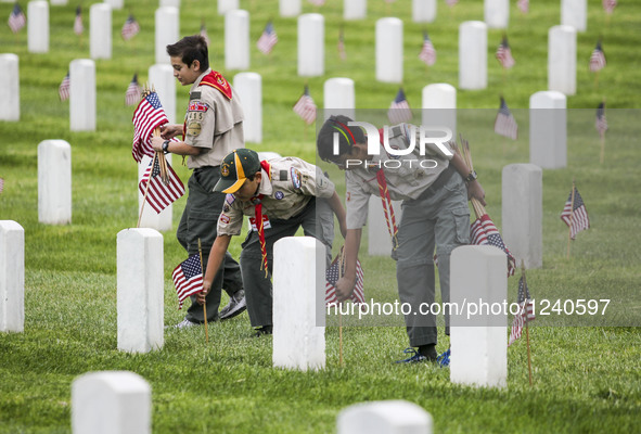 Boy scouts carry U.S. flags to plant at each grave at the Los Angeles National Cemetery, for the Memorial Day in Los Angeles, California, th...