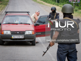 Police special opps check a car on the road to Donetsk (