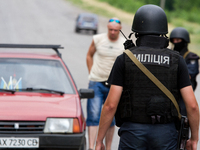 Police special opps check a car on the road to Donetsk (