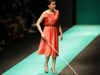 A blind woman navigates her way as she presents a creation of ESAC apparel during the Philippine Fashion Week held at the SMX Convention Cen...