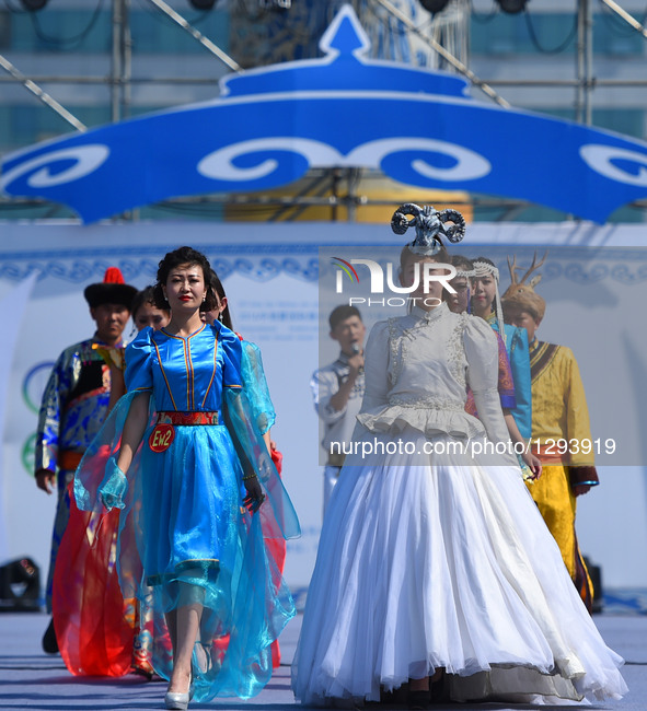 Models present costumes at Sino-Russian-Mongolian Costume Festival in Hulunbuir, north China's Inner Mongolia Autonomous Region, June 24, 20...
