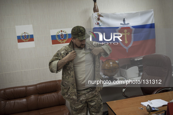 The commander of the Russian Orthodox Army seen inside his office in the unit's headquarters in the occupied SBU building in Donetsk, easter...
