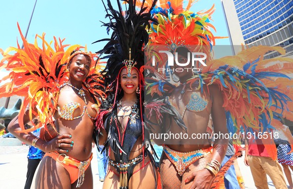 Dressed up revellers perform during the official launch ceremony of the 2016 Toronto Caribbean Carnival at Nathan Philips Square in Toronto,...