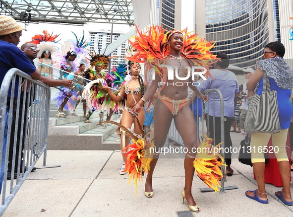 Dressed up revellers perform during the official launch ceremony of the 2016 Toronto Caribbean Carnival at Nathan Philips Square in Toronto,...