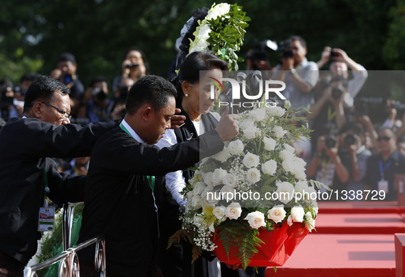 Myanmar's State Counselor Aung San Suu Kyi, daughter of General Aung San, pays tribute during a ceremony to mark the 69th Martyrs' Day in Ya...