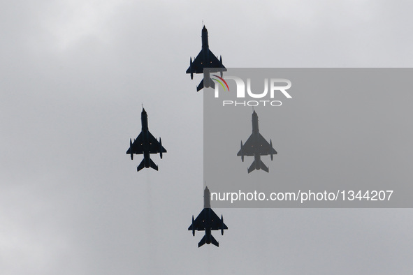 A formation of MIG-21 Lancer military airplanes participate a ceremony marking Romania's Air Forces Day in Bucharest, July 20, 2016.