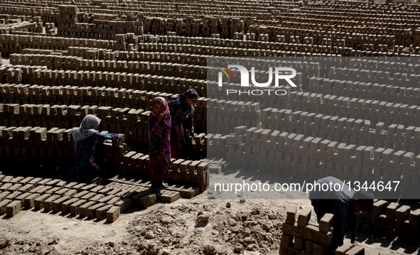 Afghan children work at a brick factory in Kabul, capital of Afghanistan, July 21, 2016. Some 1.3 million school-aged Afghan children are de...