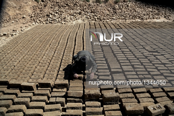 An Afghan child works at a brick factory in Kabul, capital of Afghanistan, July 21, 2016. Some 1.3 million school-aged Afghan children are d...