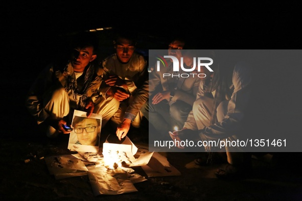 People attend a candlelight vigil to commemorate victims of Kabul twin bomb attack in Ghazni province, Afghanistan, July 24, 2016. In total...