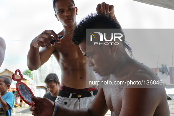 Tacloban, Philippines - Mark Largo, 23 has a haircut taken in Tacloban City on June 11, 2014. On November 8, 2013, Haiyan, one of the most p...