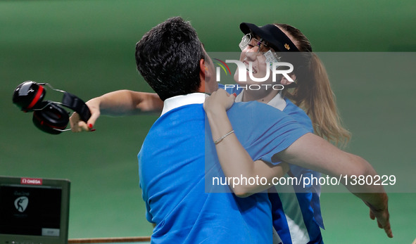 Anna Korakaki (R) of Greece hugs with her coach, also her father after the women's 25m pistol final of shooting at the 2016 Rio Olympic Game...