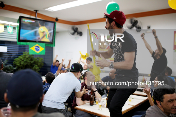 People celebrate Brazil's first goal of the match of the World Cup between Brazil and Croatia in a bar on the east side of São Paulo, Brazil...