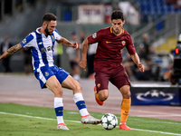 Diego Perotti of Roma is challenged by Miguel Layun of Porto during the UEFA Champions League playoff match between AS Roma and FC Porto, at...