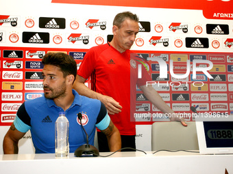 Olympiaco's Portuguese head coach Paulo Bento (R) and Olympiaco's Spanish defender Alberto Botia (L) during the press conference of UEFA Eur...