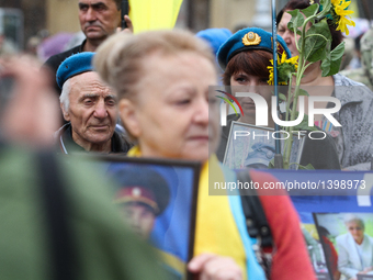 Fighters of volunteer battalions, relatives of those killed during the fighting in Donbas march downtown Kiev with 